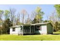 Inviting home featuring a covered porch and well-maintained lawn at 9067 Old Haggard Rd, Morgantown, IN 46160