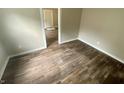 Cozy bedroom featuring hardwood floors, fresh paint, and ample space for comfortable living at 1019 E Jackson St, Shelbyville, IN 46176
