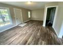 Well-lit living room with hardwood flooring, neutral paint, and a welcoming entrance at 1019 E Jackson St, Shelbyville, IN 46176