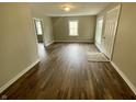 Open living room showcases hardwood flooring, neutral paint, bright natural light, and an inviting atmosphere at 1019 E Jackson St, Shelbyville, IN 46176