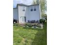 Backyard featuring a wooden deck with patio seating, plants, well-maintained lawn and siding in a residential area at 10190 Holly Berry Cir, Fishers, IN 46038