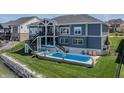 Spacious backyard featuring a refreshing pool, comfortable seating, and a serene outdoor setting for relaxation and enjoyment at 10590 Geist View Dr, Fishers, IN 46055