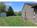 Spacious, green backyard featuring a storage shed and views of the surrounding landscape at 109 Buckthorne Ln, Mooresville, IN 46158
