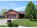 Beautiful one-story home with brick accents, an attached garage, and an established lawn and landscaping at 109 Buckthorne Ln, Mooresville, IN 46158