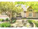 Charming entrance with a covered porch and lush landscaping at 10919 Running Tide Ct, Indianapolis, IN 46236