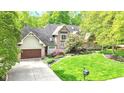 Beautiful two-story brick home with a well-manicured lawn and mature trees at 10919 Running Tide Ct, Indianapolis, IN 46236