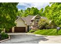 Beautiful two-story home with a well-maintained lawn and lush greenery around the property at 10919 Running Tide Ct, Indianapolis, IN 46236