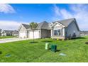 Beautifully landscaped home with a well-maintained lawn, a two-car garage, and a serene neighborhood setting at 110 Maxim Ct, Cumberland, IN 46229