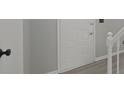 Close up on a white interior door with black hardware, light gray walls, white trim and gray laminate flooring at 11212 Bayridge E Cir, Indianapolis, IN 46236