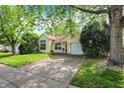 Charming yellow house with a well-maintained lawn and attached garage on a sunny day at 1127 Jody Ct, Greenwood, IN 46143