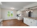 Kitchen area featuring wood flooring, white cabinetry, and a convenient coffee station with natural light at 1285 S 1100 E, Zionsville, IN 46077