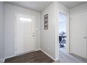 Welcoming foyer with dark wood floors that leads to a study at 13451 All American Rd, Fishers, IN 46037