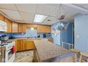 Functional kitchen with wooden cabinets, laminate countertops, and island seating at 150 Church St, Mooresville, IN 46158