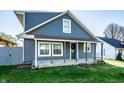 View of an attractive two-story home with a quaint covered front porch at 1509 S Spencer Ave, Indianapolis, IN 46203
