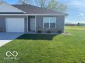 Inviting single-story home with a manicured lawn and blue sky at 1511 Coen Ct, Columbus, IN 47201