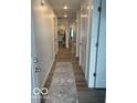 Bright hallway with wood-look floors and a decorative runner at 1511 Coen Ct, Columbus, IN 47201