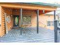 Charming covered porch with wood floors, string lights and a bench, perfect for relaxing outdoors at 1630 Hinson Rd, Martinsville, IN 46151