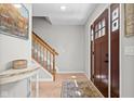 Inviting foyer features hardwood floors, staircase, and a decorative rug, leading to the home's interior at 18811 Orleans Ct, Noblesville, IN 46060