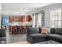 Open-concept living space with a kitchen featuring a breakfast bar and seamless connection to living area at 18811 Orleans Ct, Noblesville, IN 46060