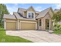 Attractive two-story home boasting a three-car garage, stone accents, and a covered porch, offering great curb appeal at 19552 Wagon Trail Dr, Noblesville, IN 46060
