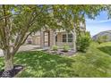 Beautiful front porch featuring stone columns and decorative railing, surrounded by green lawn and mature landscaping at 19552 Wagon Trail Dr, Noblesville, IN 46060