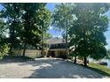 Beautiful home exterior with a large driveway, lush landscaping, and lake access at 2001 E Ely Ct, Martinsville, IN 46151