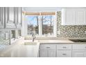 Bright kitchen with white cabinets, modern appliances, and a beautiful view of the lake at 2001 E Ely Ct, Martinsville, IN 46151