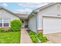 The home has a covered entrance porch with decorative plants and a seating area near the front door at 2125 Jason Dr, Lebanon, IN 46052
