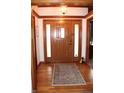 Warm foyer featuring hardwood floors, decorative rug, and a beautiful wooden front door with glass panels at 215 Fairway Ct, Franklin, IN 46131