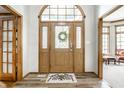 Inviting foyer features a decorative glass door, wood floors, and views into other rooms at 225 Yorkshire E Blvd, Indianapolis, IN 46229