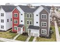 Aerial view of townhomes featuring a black roof, colorful facades, and well-manicured front yards at 2418 Winthrop Ave, Indianapolis, IN 46205