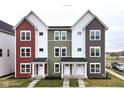 Townhomes featuring colorful facades, white trim, and well-manicured front yards at 2418 Winthrop Ave, Indianapolis, IN 46205