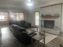 Comfortable living room featuring a brick fireplace, wood floors, and a view into the kitchen at 2550 16Th St, Columbus, IN 47201