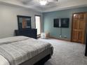 Spacious main bedroom with plush carpeting, ceiling fan, and an ensuite bathroom at 2550 16Th St, Columbus, IN 47201