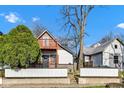 Two-story home with a modern exterior, attractive wooden porch, and landscaping at 257 N Tacoma Ave, Indianapolis, IN 46201