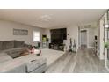 Cozy living room boasts modern gray flooring, an entertainment center, and a comfortable sectional couch at 2658 S Rybolt Ave, Indianapolis, IN 46241