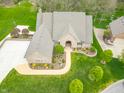 Beautiful home featuring manicured lawn, mature trees, and a charming walkway at 2733 Foxborough Dr, Greenwood, IN 46143