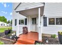 Inviting front porch featuring a charming bench, providing a warm welcome to the home at 301 S B St, Thorntown, IN 46071