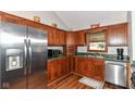 Efficient kitchen featuring wood cabinets, stainless steel appliances, and a cozy window at 3027 Ash Way, Lapel, IN 46051
