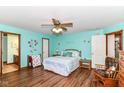 Bright and spacious main bedroom with laminate flooring, ceiling fan, and ensuite bathroom at 3027 Ash Way, Lapel, IN 46051