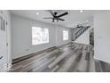 Bright and airy living room featuring modern ceiling fans, stylish floors, and staircase at 3132 Indianapolis Ave, Indianapolis, IN 46208