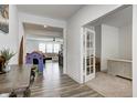 Bright foyer with wood-look flooring providing easy access to living spaces and home office with French doors at 3148 Hawking Ct, Danville, IN 46122