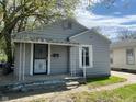 Charming home featuring gray siding, covered front porch, and well-maintained yard at 3541 Orchard Ave, Indianapolis, IN 46218