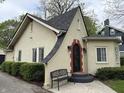 Charming home with a decorative wrought-iron door and manicured bushes with a bench at 421 W 44Th St, Indianapolis, IN 46208
