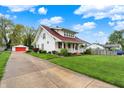 Charming two-story home with new roof, front porch, long driveway, and detached two car garage at 429 E Main St, Whiteland, IN 46184