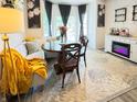 Inviting dining area with large windows, a cozy banquette, elegant lighting, and stylish decor for Gathering meals at 5839 W Commonview Dr, McCordsville, IN 46055