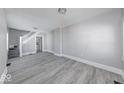 Bright and spacious living room featuring modern floors, neutral paint, and ample natural light at 623 Arbor Ave, Indianapolis, IN 46221