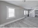 Open-concept living area with large windows and modern flooring, freshly painted and ready to enjoy at 623 Arbor Ave, Indianapolis, IN 46221