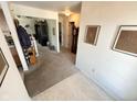 View of the hall with carpet flooring, an antique grandfather clock, and white walls at 6231 Oak Limb Ct, Indianapolis, IN 46221