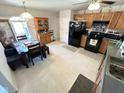 Traditional kitchen with black appliances, tile flooring, and plenty of cabinet space at 6231 Oak Limb Ct, Indianapolis, IN 46221